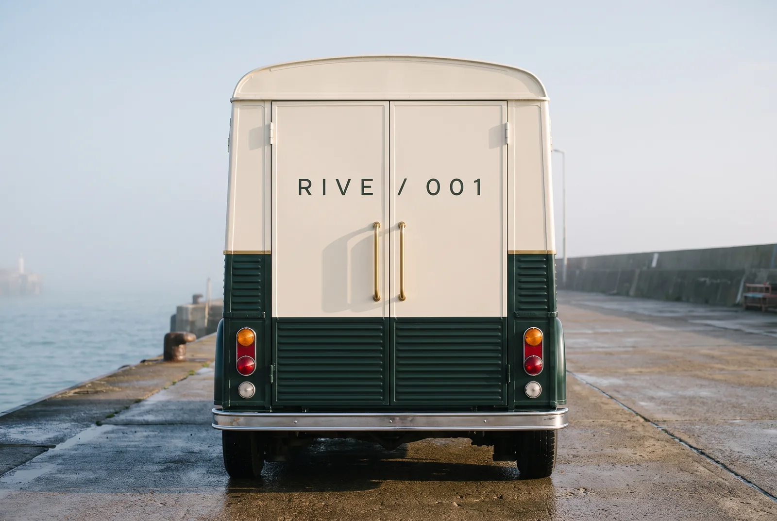 The rear doors of the truck in ivory cream, marked RIVE / 001, with two brass handles.